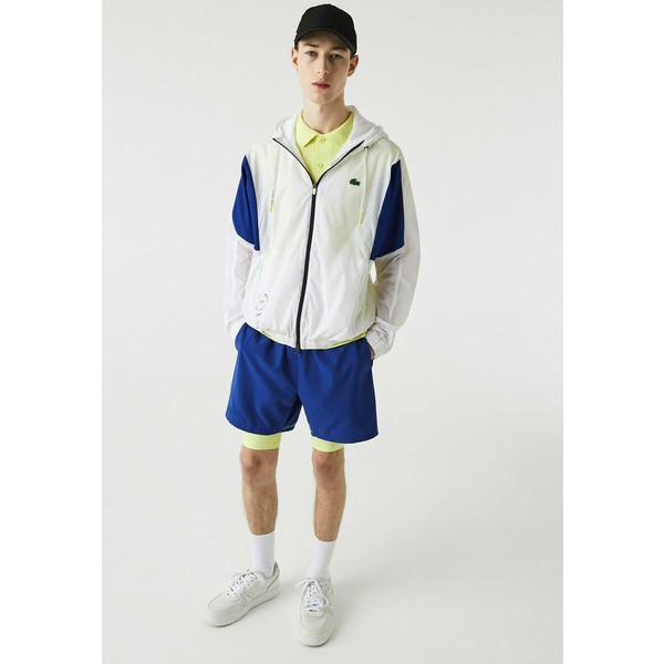 ラコステ メンズ コート アウター Training jacket - blanc bleu jaune fluo noir blanc bleu jaune fluo noir