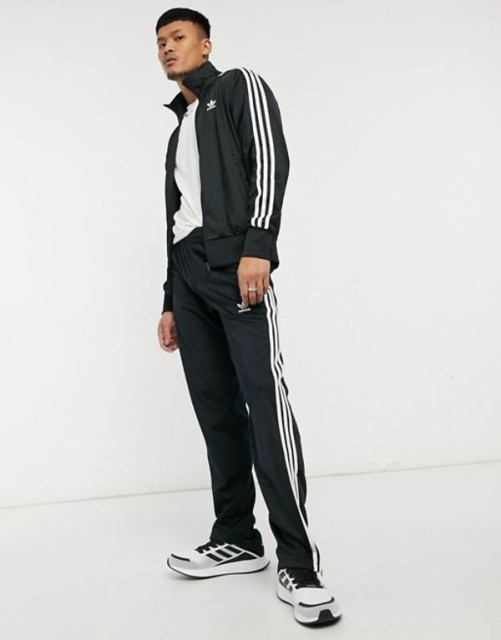 アディダス メンズ カジュアルパンツ ボトムス adidas Originals adicolor Firebird three stripe sweatpants in black Black