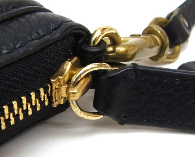 TORY BURCH 二つ折り財布 ﾗｳﾝﾄﾞｼﾞｯﾌﾟ ﾛｺﾞ 黒 ﾚｻﾞｰ 【中古】(62542)の