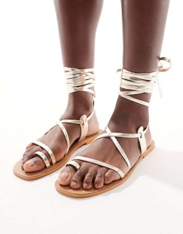 エイソス レディース サンダル シューズ ASOS DESIGN Finland leather strappy toe-loop flat sandals in gold GOLD