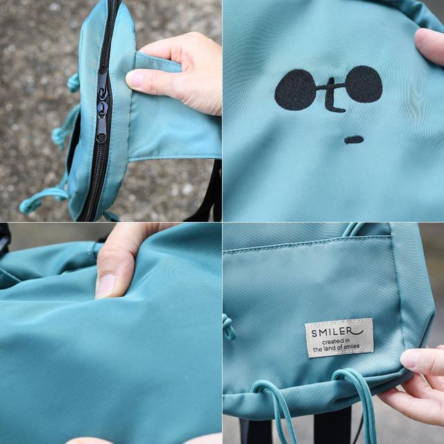 メインポケットはWファスナー開閉です。BUDDYくんはSMILERのオリジナルキャラクターです。高密度で軽量のポリエステルが使用されています。本体下部にはブランドの織りネームが縫い付けられております。